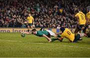 26 November 2016; Garry Ringrose of Ireland scores his side's second try despite the tackle of Dean Mumm of Australia during the Autumn International match between Ireland and Australia at the Aviva Stadium in Dublin. Photo by Brendan Moran/Sportsfile