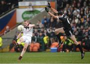 27 November 2016; Christopher Bradley of Slaughtneil scoring a point dispite the attempted block of Aidan Branagan of Kilcoo during the AIB Ulster GAA Football Senior Club Championship Final game between Slaughtneil and Kilcoo at the Athletic Grounds in Armagh. Photo by Oliver McVeigh/Sportsfile