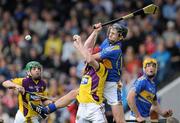 17 April 2011; Michael Heffernan, Tipperary, in action against Paul Roche, Wexford, as Pa Bourke, Tipperary, and Lar Prendergast, Wexford, look on. Allianz Hurling League, Division 1, Round 7, Tipperary v Wexford, Semple Stadium, Thurles, Co. Tipperary. Picture credit: Brian Lawless / SPORTSFILE
