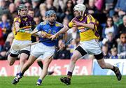 17 April 2011; Benny Dunne, Tipperary, in action against P.J. Nolan, left, and Ciaran Kenny, Wexford. Allianz Hurling League, Division 1, Round 7, Tipperary v Wexford, Semple Stadium, Thurles, Co. Tipperary. Picture credit: Brian Lawless / SPORTSFILE