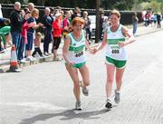 17 April 2011; Bernie Manley, Raheny Shamrocks A.C, hands over to teammate Anne Reede for the second leg during the Master Womens Road Relay. Woodie’s DIY Road Relay Championships of Ireland. Raheny, Dublin. Picture credit: Tomas Greally / SPORTSFILE