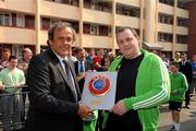 19 April 2011; UEFA President Michel Platini makes a presentation to Anto Reilly, Hardwicke F.C., after he visited the club's facilities and the Football for All Programme while in Dublin for the UEFA Europa League Trophy Handover in advance of the UEFA Europa League final, to be played at the Aviva Stadium on Wednesday 18 May. Hardwicke Street, Dublin. Picture credit: Ray McManus / SPORTSFILE