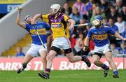 17 April 2011; Benny Dunne, Tipperary, in action against John Coghlan, Wexford. Allianz Hurling League, Division 1, Round 7, Tipperary v Wexford, Semple Stadium, Thurles, Co. Tipperary. Picture credit: Brian Lawless / SPORTSFILE