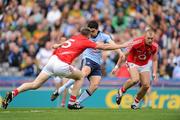 24 April 2011; Bernard Brogan shoots past Cork full-back Michael Shields, right, and Noel O'Leary on his way to scoreing the second goal for Dublin. Allianz Football League Division 1 Final, Dublin v Cork, Croke Park, Dublin. Picture credit: Ray McManus / SPORTSFILE