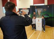 29 April 2011; Mark Kinsella, from Blanchardstown, takes a picture of his son's Christopher, back, Jamie and Rossat, right, with the UEFA Cup before the Bohemians v Derry City game. St. Peters National School, St. Peters Road, Dublin. Picture credit: Matt Browne / SPORTSFILE