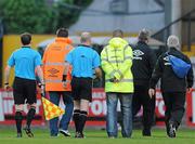 29 April 2011; Match referee Padraig Sutton, third from left, is escorted off the pitch at half time by security. Airtricity League Premier Division, Bohemians v Derry City, Dalymount Park, Dublin. Picture credit: Matt Browne / SPORTSFILE