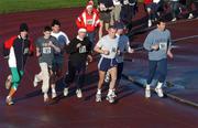 25 December 2001; Participants make their way around the third bend during a Christmas Day Goal Miles Run at Belfield Park in Dublin. Photo by Ray McManus/Sportsfile