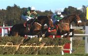29 December 2001; Istabraq, with Charlie Swan up, left, jumps the last alongside Bust Out, with Barry Geraghty up, on their way to winning the on Day Four of the Leopardstown Christmas Festival at Leopardstown Racecourse in Dublin. Photo by Brendan Moran/Sportsfile