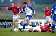 6 January 2002; Darren McKenna of Monagahan United in action against Tony McCarthy and John Burns of Shelbourne during the eircom League Premier Division match between Monaghan United and Shelbourne at Century Homes Park in Monaghan. Photo by David Maher/Sportsfile