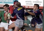 12 January 2002; Jason Holland of Munster is tackled by Gregor Townsend, left, and Norman Berryman of Castres during the Heineken Cup Pool 4 Round 6 match between Castres and Munster at Stade Pierre-Antoine in Castres, France. Photo by Brendan Moran/Sportsfile