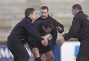 15 January 2002; Anthony Foley is tackled by Brian O'Driscoll, from left, Kevin Maggs and Alan Quinlan during a Ireland Rugby squad training session and press conference at Thomond Park in Limerick. Photo by Matt Browne/Sportsfile