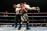 5 November 2016; Paddy Barnes is lifted by Stefan Slavchev in the fourth round, resulting in the stoppage of their flyweight bout at the Titanic Exhibition Centre in Belfast. Photo by Ramsey Cardy/Sportsfile