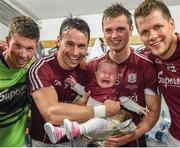 17 July 2016; Finian Hanley, with his daughter Freya, age 5 months, and Galway team-mates, from left, Gareth Bradshaw, Liam Silke and Johnny Heaney celebrate following the Connacht GAA Football Senior Championship Final Replay match between Galway and Roscommon at Elverys MacHale Park in Castlebar, Co Mayo. Photo by Stephen McCarthy/Sportsfile