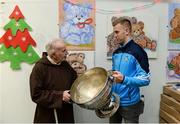21 December 2016; Dublin footballer Jonny Copper with Br. Kevin Crowley and the Sam Maguire Cup as they lend a hand packing some of the 3,000 Christmas parcels for the homeless at the Capuchin Day Centre on Bow Street, Dublin. Photo by Piaras Ó Mídheach/Sportsfile