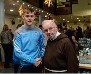 21 December 2016; Dublin footballer Con O'Callaghan with Br. Kevin Crowley as they lend a hand packing some of the 3,000 Christmas parcels for the homeless at the Capuchin Day Centre on Bow Street, Dublin. Photo by Piaras Ó Mídheach/Sportsfile