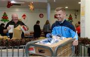 21 December 2016; Dublin footballer Jonny Cooper lends a hand packing some of the 3,000 Christmas parcels for the homeless at the Capuchin Day Centre on Bow Street, Dublin. Photo by Piaras Ó Mídheach/Sportsfile