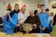 21 December 2016; Dublin footballers Jonny Cooper, left, and Con O'Callaghan with Br. Kevin Crowley and Alan Bailey, from the Capuchin Day Centre, and the Sam Maguire Cup, as they lend a hand packing some of the 3,000 Christmas parcels for the homeless at the Capuchin Day Centre on Bow Street, Dublin. Photo by Piaras Ó Mídheach/Sportsfile
