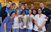 25 December 2016; Dublin players Brian Fenton, John Small, James McCarthy, Tomás Brady, Stephen Cluxton and Ciaran Kilkenny with staff nurses Maeve McBrede, Sarah McCormack, Mary Joseph, Fiona Little, Junely Lopez and Jian Hua Zheng and the Sam Maguire Cup during a visit to Beaumont Hospital in Beaumount, Dublin. Photo by Ray McManus/Sportsfile