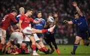 26 December 2016; Conor Murray of Munster kicks over the blockdown efforts of Jack Conan and Cian Healy, right, of Leinster during the Guinness PRO12 Round 11 match between Munster and Leinster at Thomond Park in Limerick. Photo by Brendan Moran/Sportsfile