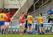 22 May 2011; Graham Kelly, Clare, 10, is shown the red card by referee Eddie Kinsella before headbutting Cork's John Miskella, left. Munster GAA Football Senior Championship Quarter-Final, Cork v Clare, Pairc Ui Chaoimh, Cork. Picture credit: Pat Murphy / SPORTSFILE