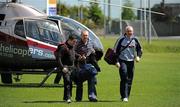 22 May 2011; The Westmeath manager Brian Hanley, right, and Shane Briody and Aidan Davitt, left, after they arrived at Dr Cullen Park, back pitch, in a helicopter. Leinster GAA Hurling Senior Championship First Round, Carlow v Westmeath, Dr. Cullen Park, Carlow. Picture credit: Ray McManus / SPORTSFILE