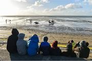 1 January 2017; Spectators look on as horses and jockeys race during the Ballyheigue Races on Ballyheigue beach on the edge of the North Atlantic ocean in Co. Kerry. Photo by Brendan Moran/Sportsfile