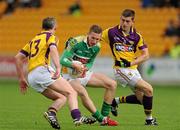 28 May 2011; Anton Sullivan, Offaly, in action against Colm Morris, left, and Adrian Flynn, Wexford. Leinster GAA Football Senior Championship First Round, Wexford v Offaly, O'Connor Park, Tullamore, Co. Offaly. Picture credit: Pat Murphy / SPORTSFILE