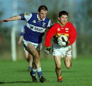 13 January 2002; Willie Quinlan of Carlow in action against Derek Conroy of Laois during the O'Byrne Cup semi-final match between Carlow and Laois at McCann Park in Portarlington, Laois. Photo by Damien Eagers/Sportsfile