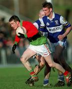 13 January 2002; Mark Carpenter of Carlow in action against Noel Garvan of Laois during the O'Byrne Cup semi-final match between Carlow and Laois at McCann Park in Portarlington, Laois. Photo by Damien Eagers/Sportsfile
