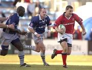 12 January 2002; Jason Holland of Munster races clear of Castres duo Ismaele Lassissi, left, and Gregor Townsend during the Heineken Cup Pool 4 Round 6 match betweeen Castres and Munster at Stade Pierre Antoine in Castres, France. Photo by Brendan Moran/Sportsfile