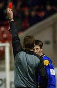 1 February 2002; Referee Dick O'Hanlon sends Longford's Stuart Byrne off, after he received his second yellow card during the Eircom League Premier Division match between Shelbourne and Longford Town at Tolka Park in Dublin. Photo by Brian Lawless/Sportsfile