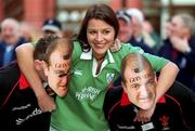 2 February 2002; Model Natasha Byram, from Dublin, gets to  grips with Welsh fans Craig and Graham Sellwood from Newport, South Wales at a photocall to announce that Guinness, official beer sponsors to the Irish team rugby team, will distribute 10,000 facemask look-alikes of Irish rugby legend Peter Clohessy to supporters heading to the Ireland and Wales Six Nations Championship match at Lansdowne Road. Photo by Ray McManus/Sportsfile