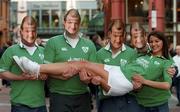 2 February 2002; Model Natasha Byram, from Dublin, with Clontarf rugby players Paul Ryan, Robert Ryan, Conor Redmond and John O'Driscoll, at a photocall to announce that Guinness, official beer sponsors to the Irish team rugby team, will distribute 10,000 facemask look-alikes of Irish rugby legend Peter Clohessy to supporters heading to the Ireland and Wales Six Nations Championship match at Lansdowne Road. Photo by Ray McManus/Sportsfile