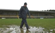 3 February 2002; A member of the TG4 crew walks across the waterlogged pitch which caused the game to be postponed prior to the Allianz National League Division 1A Round 1 match between Donegal and Galway at MacCumhaill Park in Ballybofey, Donegal. Photo by Damien Eagers/Sportsfile