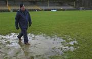 3 February 2002; A member of the TG4 crew walks across the waterlogged pitch which caused the game to be postponed prior to the Allianz National League Division 1A Round 1 match between Donegal and Galway at MacCumhaill Park in Ballybofey, Donegal. Photo by Damien Eagers/Sportsfile