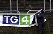 3 February 2002; Jimmy Breathnach a member of the TG4 crew takes down a sign after the game is postponed prior to the Allianz National League Division 1A Round 1 match between Donegal and Galway at MacCumhaill Park in Ballybofey, Donegal. Photo by Damien Eagers/Sportsfile