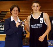 4 February 2002; Belvedere College captain Simon Flynn is presented with the cup by Andrea Dillon of Bank of Ireland following the Bank of Ireland Schools Cup U-16 B Final between Belvedere College, Dublin and CBS Naas, Kildare at ESB Arena in Tallaght, Dublin. Basketball. Photo by Brendan Moran/Sportsfile