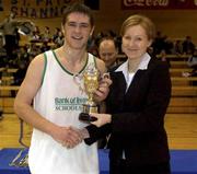5 February 2002; Tralee Community College captain Martin Ferris receives the cup from Bank of Ireland representative Caragh Downiy following the Bank of Ireland Schools Cup U19 B Final between St Muredach's College, Ballina and Tralee Community College at the ESB Arena in Tallaght, Dublin. Photo by Brendan Moran/Sportsfile
