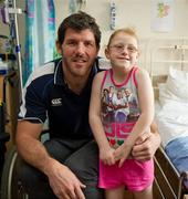 30 May 2011; Leinster's Shane Horgan with seven year old Rachael Mangan, from Clare Hall, Dublin, during a visit to Temple Street Children's University Hospital by members of the winning Heineken Cup team. The Children's University Hospital, Temple Street, Dublin. Picture credit: Ray McManus / SPORTSFILE