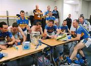 5 September 2010; Tribal rite. Tipperary players celebrate around the Liam MacCarthy Cup following its safe arrival back into their dressing room. Picture credit: Ray McManus / SPORTSFILE