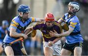 8 January 2017; Damien Reck of Wexford is tackled by Eddie Hayden, left, and Huw Lawlor of UCD during the Bord na Mona Walsh Cup Group 3 Round 1 match between Wexford and UCD at Páirc Uí Suíochan in Gorey, Co. Wexford. Photo by Ramsey Cardy/Sportsfile