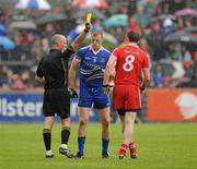 5 June 2011; Referee Cormac Reilly issues a yellow card to Eoin Lennon, Monaghan, and Aidan Casssidy, Tyrone, in the first half. Ulster GAA Football Senior Championship Quarter-Final, Healy Park, Tyrone v Monaghan, Omagh, Co. Tyrone. Picture credit: Oliver McVeigh / SPORTSFILE