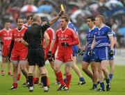5 June 2011; Referee Cormac Reilly shows a yellow card to Martin Penrose, Tyrone. Ulster GAA Football Senior Championship Quarter-Final, Healy Park, Tyrone v Monaghan, Omagh, Co. Tyrone. Picture credit: Oliver McVeigh / SPORTSFILE