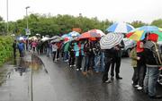 5 June 2011; Supporters queue in the rain to gain entry to the covered stand. Ulster GAA Football Senior Championship Quarter-Final, Healy Park, Tyrone v Monaghan, Omagh, Co. Tyrone. Picture credit: Oliver McVeigh / SPORTSFILE