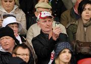 5 June 2011; A Tyrone fan takes a picture on his camera phone from the stand. Ulster GAA Football Senior Championship Quarter-Final, Healy Park, Tyrone v Monaghan, Omagh, Co. Tyrone. Picture credit: Oliver McVeigh / SPORTSFILE