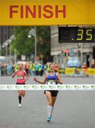 6 June 2011; Donegal's Catriona Jennings crosses the finish line to win the 2011 Flora Womens Mini Marathon ahead of second placed Siobhan O'Doherty, Nenagh, Co. Tipperary, left. 2011 Flora Womens Mini Marathon, Dublin City. Picture credit: Pat Murphy / SPORTSFILE