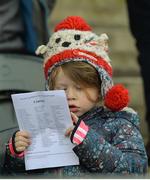 15 January 2017; Young Cork supporter Lilly O'Brien, age 5, from Belgooly, Co. Cork, studies the match day programme before the McGrath Cup Round 3 match between Cork and Kerry at Mallow GAA Grounds in Mallow, Co Cork. Photo by Eóin Noonan/Sportsfile