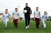 16 January 2017; Dublin footballer Philly McMahon runs with students, from left, Nicole Cleary, age 11, from St Brigid's GNS, Jamie Smyth, age 11, from Scoil Chiarain CBS, Sean McHugh, age 11, from Scoil Chiarain CBS, and Aine O'Toole, age 8, from St Brigid's GNS, at the GAA Healthy Clubs launch at Craobh Chiarain GAA Club, Parnell Park in Donnycarney, Dublin. The GAA launched the next stage of their pioneering project to transform Ireland's GAA clubs into ground-breaking healthy hubs. The launch intends to encourage more GAA clubs to get involved to support communities in pursuit of better physical, social and mental wellbeing. Photo by Cody Glenn/Sportsfile