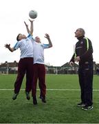 16 January 2017; Tyrone manager Mickey Harte throws a high ball in for classmates Sean McHugh, left, and Jamie Smyth, both age 11, from Scoil Chiarain CBS, at the GAA Healthy Clubs launch at Craobh Chiarain GAA Club, Parnell Park in Donnycarney, Dublin. The GAA launched the next stage of their pioneering project to transform Ireland's GAA clubs into ground-breaking healthy hubs. The launch intends to encourage more GAA clubs to get involved to support communities in pursuit of better physical, social and mental wellbeing. Photo by Cody Glenn/Sportsfile