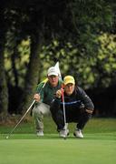 16 June 2011; Alex Hjalmarsson, Sweeden, lines up his putt on the 3rd alongside his caddy Alistair Calvert, Australia, during the 74th World Open One Armed Championships final. Co. Meath Golf Club, Newtownmoynagh, Trim, Co. Meath. Picture credit: Barry Cregg / SPORTSFILE
